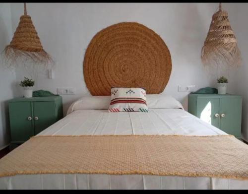 a bedroom with a large bed and two green cabinets at Casa Rural la Sierra del Viento in Guadalcanal