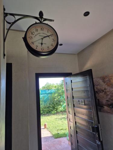 a clock hanging over a door with a window at Villa-l-arganier - Piscine - Sans vis-à-vis in Eddir