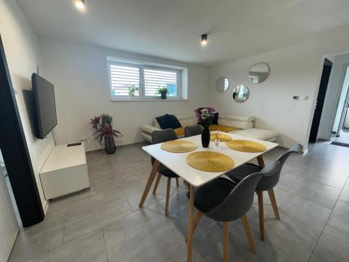 a living room with a table and chairs in a room at U Harryho Pottera in Spišská Nová Ves