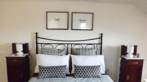 a bedroom with a bed with two pictures on the wall at Domus Tua in Pietrelcina