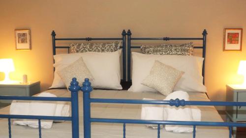 a bedroom with a bed with white pillows at Domus Tua in Pietrelcina