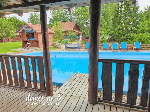 a view of a swimming pool from a porch at Łęgowska Dolina in Olecko
