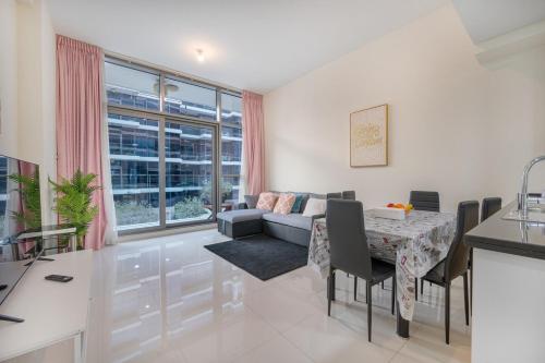 a living room with a table and a couch at Quickstay holiday homes1BHK Retreat Peaceful & Bright in Dubai