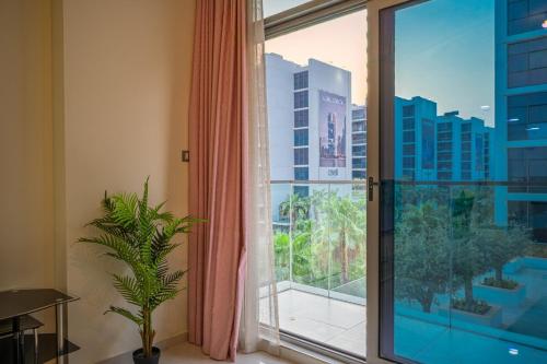 a large window with a view of a city at Quickstay holiday homes1BHK Retreat Peaceful & Bright in Dubai