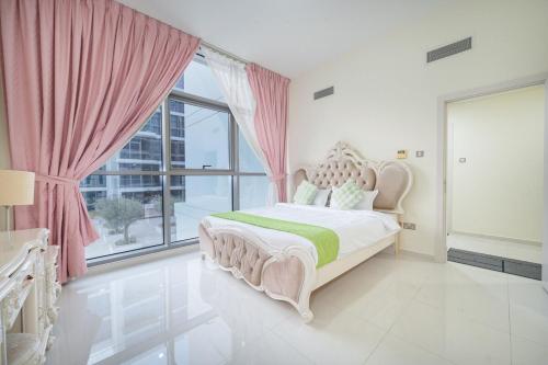 a bedroom with a bed and a large window at Quickstay holiday homes1BHK Retreat Peaceful & Bright in Dubai