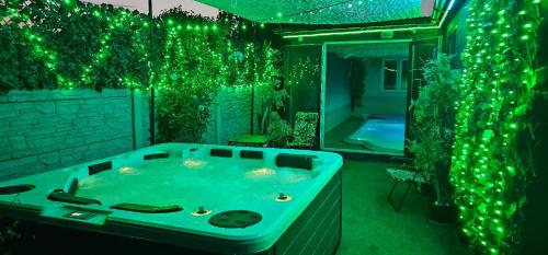 a large bathroom with a tub with green lights at ZAJAZD ALBATROS Rzeszów SPA in Rzeszów