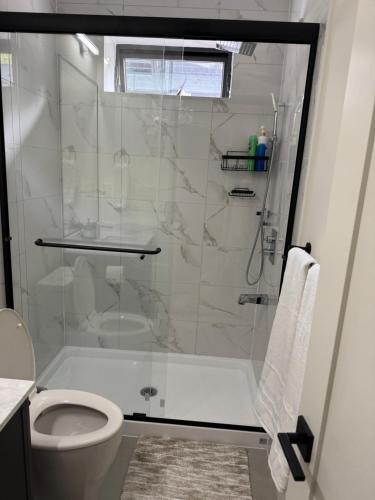 a bathroom with a shower and a toilet at Beautiful 2 Bedroom suite in White Rock