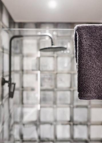 a towel hanging on a rack in a bathroom at Reve Suites Ioannina in Ioannina