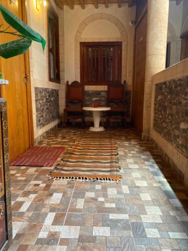 a hallway with a table and a table in a building at RIAD Tamazouzt in Essaouira