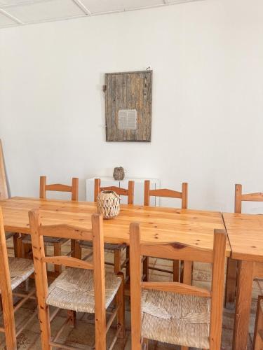 a dining room with a wooden table and chairs at Kalma - Beachfront home at the fisherman village of Marceddi in Terralba