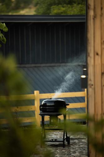 a grill on a table in front of a fence at Kasollet e zanave in Pristina