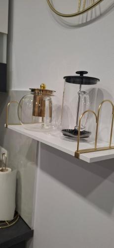 a shelf with some glass items on it at Apartament Antracyt in Wałbrzych