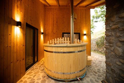 a wooden room with a wine barrel in it at Kasollet e zanave in Pristina
