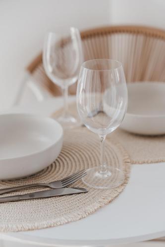 a table with two wine glasses on a table at Stella Maris in Pythagoreio