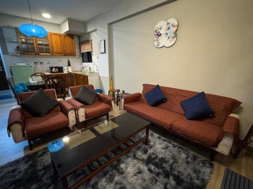 a living room with two couches and a table at Lovely apartment in Genting Highlands. in Genting Highlands