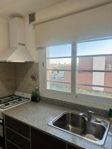 a kitchen with a sink and a window at Departamento Castello -Viedma in Viedma