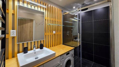 a bathroom with a sink and a washing machine at Urban Zen Stay in Banská Bystrica