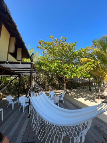 a hammock on a deck next to a house at Beach House la Tortuga, Punta Seca, Rincón del Mar 
