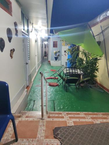 a hallway with a green floor in a room at Hostal Ruinas de San Sebastián in León