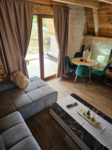 a living room with a couch and a table at Moj raj Zabljak in Borje