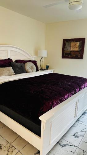 a bedroom with a large bed with a black blanket at Duplex on CANAL all updated new furniture in Rotonda West