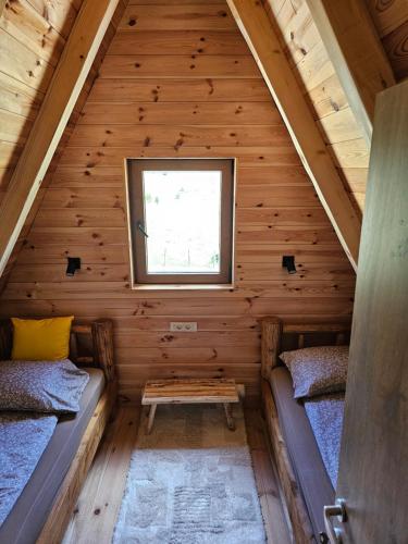 a room in a log cabin with two beds at Moj raj Zabljak in Borje