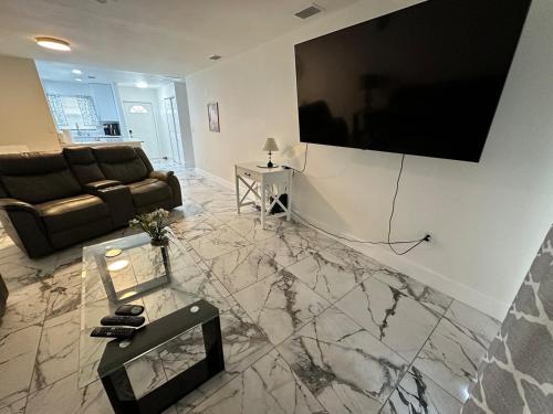 a living room with a large flat screen tv on a wall at Duplex on CANAL all updated new furniture in Rotonda West