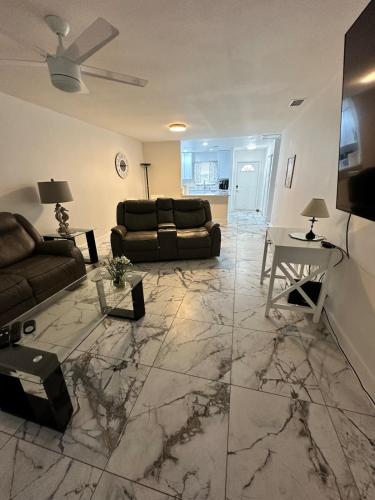 a living room with two couches and a table at Duplex on CANAL all updated new furniture in Rotonda West