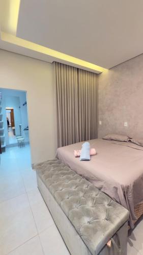 a bedroom with a large bed with a pillow on it at Casa da Mih in Tangara da Serra