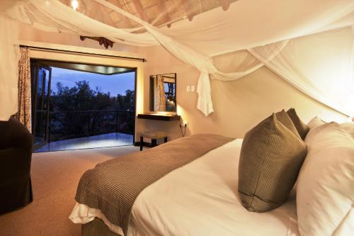 a bedroom with a bed and a balcony at The Blades in Pretoria
