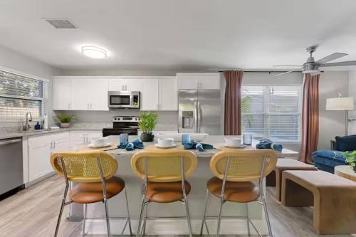 a kitchen and dining room with a table and chairs at New listing~10 min to beach~Back yard fun~Pool in Cross Bayou