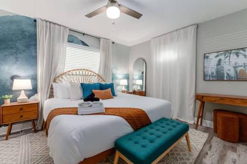 a bedroom with a large bed with a green bench at New listing~10 min to beach~Back yard fun~Pool in Cross Bayou