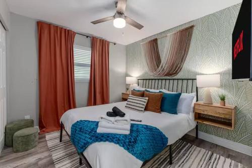 a bedroom with a large bed with a blue blanket at New listing~10 min to beach~Back yard fun~Pool in Cross Bayou