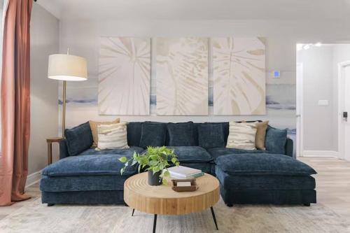 a living room with a blue couch and a table at New listing~10 min to beach~Back yard fun~Pool in Cross Bayou