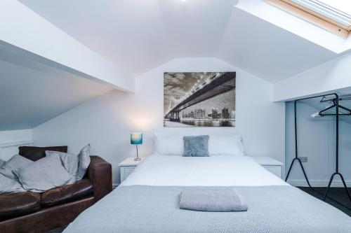 a bedroom with a bed and a couch at Four BR House By Eason Stays Short Lets & Serviced Accommodation Chorley With Free Parking in Chorley
