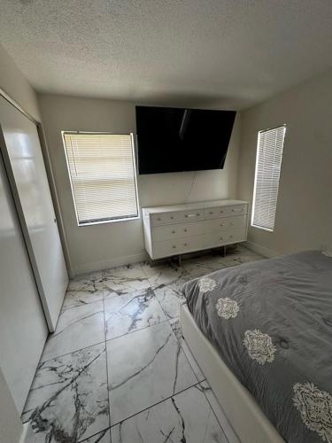 a bedroom with a bed and a flat screen tv at Canal front new everything near Boca Grande Beach in Rotonda West