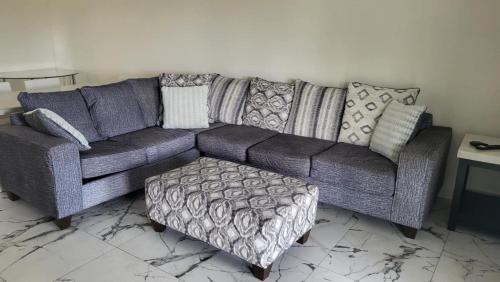 a living room with a purple couch and an ottoman at Canal front new everything near Boca Grande Beach in Rotonda West