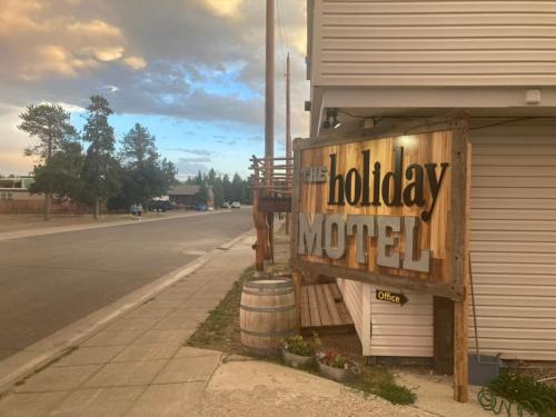 a motel sign on the side of a street at Yellowstone Holiday Motel in West Yellowstone