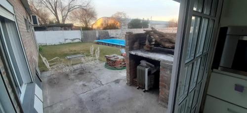 an outside view of a patio with a fireplace at La paz in Médanos