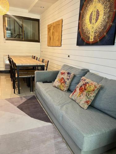 a couch in a room with a table and a dining room at La Locanda in Bangkok