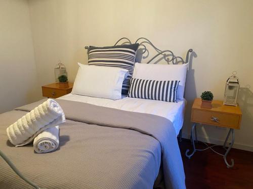 a bedroom with two beds with pillows at Waterfront Home with stunning views in Tarraville