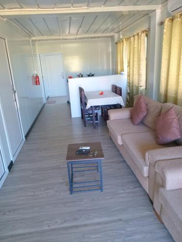 a living room with a couch and a table at Shalini Garden Hotel & Apartments in Singatoka