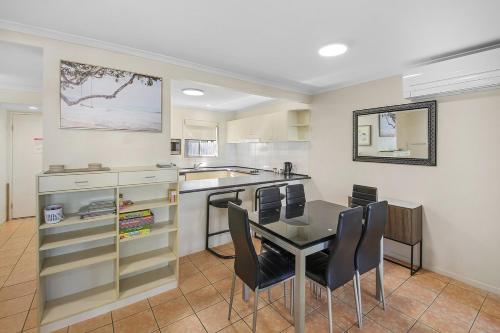 a kitchen with a table and chairs in a room at Oaks Family Getaway - Resort, Beach in Golden Beach