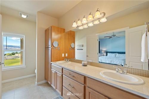 a bathroom with a sink and a large mirror at A03-Livin' Life on the Golf Course Sunserra in Quincy