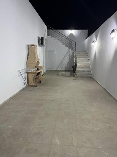a large room with stairs and a stair case at Dar Maya in Djerba