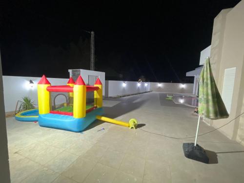 a childrens play set in a backyard at night at Dar Maya in Djerba