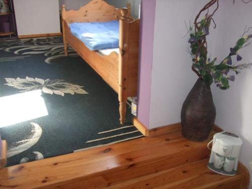 a bedroom with a bunk bed with a vase on the floor at Agroturystyka SZYSZKA in Polnica