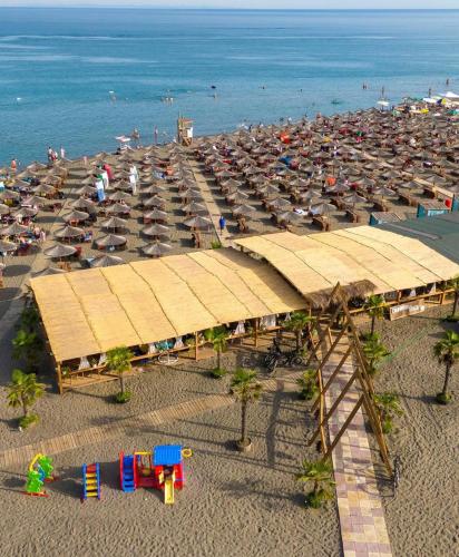 an aerial view of a beach with umbrellas and the ocean at A3 Apartments in Velipojë
