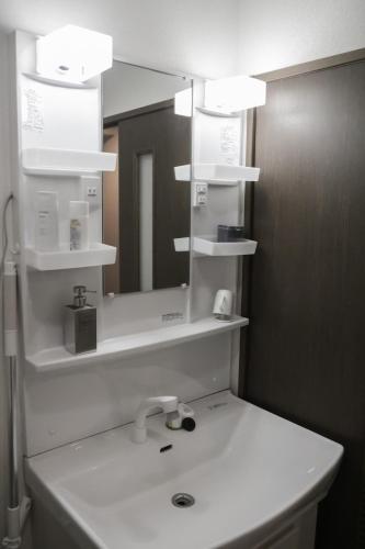 a bathroom with a sink and a mirror at matsuokabase in Kitakyushu
