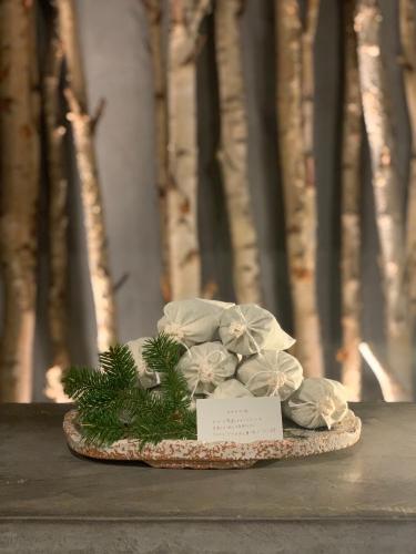 a plate of flowers on a table with trees in the background at 層雲峡温泉 ホテル雲井 in Kamikawa